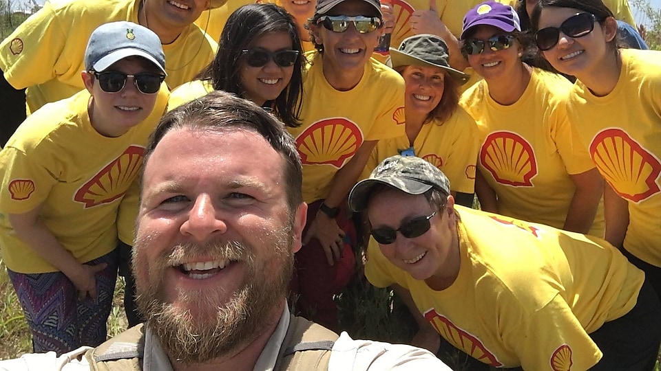 Seth Moncrief, BTNEP’s Volunteer Coordinator, snaps a happy selfie with Shell volunteers after a hard day’s work.