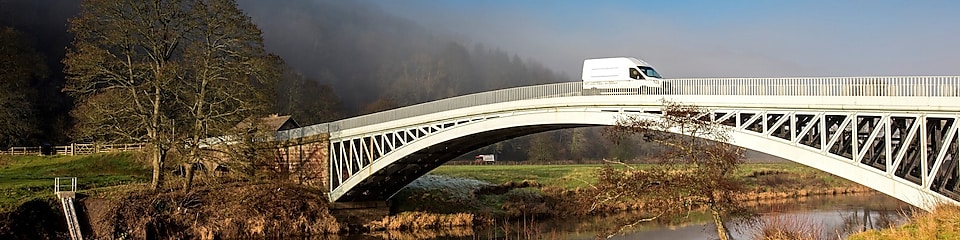 Commercial van crossing bridge