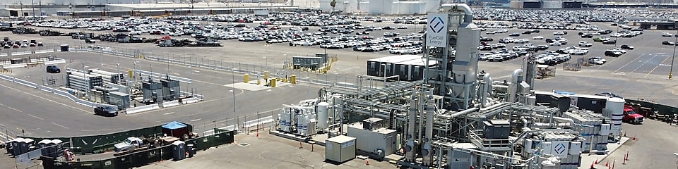 Heavy duty hydrogen fuel-cell electric truck and Toyota Mirai in front of Toyota Logistics Services