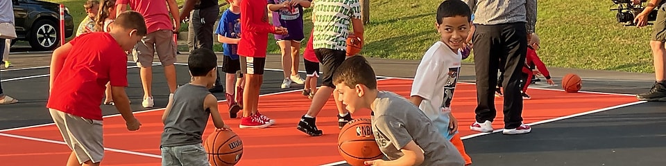 children playing basketball on court